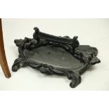 A heavy cast iron black painted Footscrapper, together with an oak copper bound Plant Stand on three
