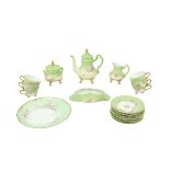 A cream and green ground D. & C France Limoges Tea Service, decorated with rose floral designs. (1)