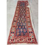 An antique silk Middle Eastern Carpet Runner, the blue ground with geometric design and stylised