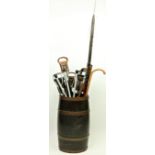 A good copper bound oak barrel Stick Stand, 24" (62cms); together with a collection of Handsticks,