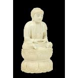 A 19th Century carved ivory Figure, modelled as a seated Buddha in prayer, with lotus leaf base,