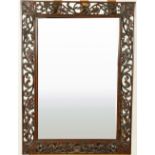 An ornate carved and pierced rosewood Mirror, with ornate scrolling vines, 28" x 20" (71cms x