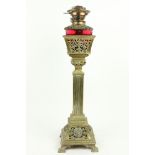 A very unusual late 19th Century brass Oil Lamp, with ruby glass reservoir cut in a pierced basket