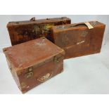 Two similar antique leather Suitcases, (labels of travel locations and hotels) together with a