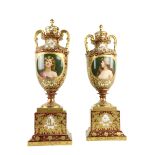 A large pair of fine quality porcelain two handled gilt decorated Urns, the tops with removable lids