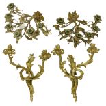 A pair of rococo style two branch brass Wall Sconces, 14 1/2" (37cms); together with a pair of six