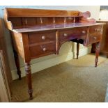 A William IV period mahogany Dressing Table, with three quarter gallery with shelf on baluster