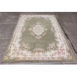 An attractive Tolech design Inolius woollen Carpet, the green ground with central floral motif and