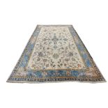 An Oriental style machine made wool Carpet, the fawn ground with all over stylized flower with