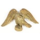 An 18th Century carved giltwood Wall Applique, modelled as an eagle perched on an oval, 9" x 16" (