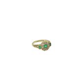 An unusual 18ct gold Cluster Ring, with circle of eight diamonds and three emeralds. (1)