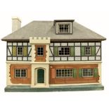 A large and very attractive Dolls House, in the form of a four bay Tudor style house with attic