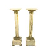 A good pair of French onyx and brass mounted Plinths, each with a square top on a cylindrical stem