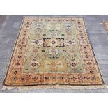 An attractive green ground heavy woollen Indian Carpet, with large similar border, approx. 235cms