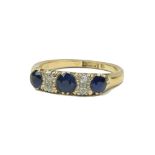 An 18ct gold Ladies Ring, set with central large blue sapphire and two smaller sapphires and