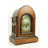 An Edwardian marquetry inlaid chiming dome top Bracket Clock, the brass and silverised dial with