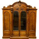 A fine quality William IV Scottish mahogany Wardrobe, the arched cornice with crest centre and