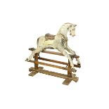 An early wooden Child's Rocking Horse, piebald colouring on wooden stand (wormed) 110cms (43"). (1)