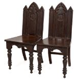 A quality pair of mahogany Gothic Revival Hall Chairs, in the manner of Pugin, the shaped backs with