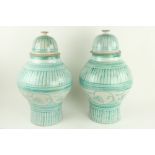 A pair of large green decorated North African pottery Vases and Covers, each of baluster form and