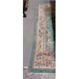 An attractive heavy woollen Chinese green ground floral decorated Carpet, approx. 253cms x 172cms (