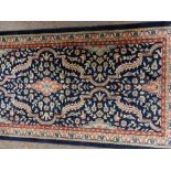 An antique style heavy woollen Indian Carpet, by 'Kaleen' the dark blue ground with multiple