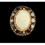 An unusual 18ct gold Ladies Ring, with attractive central oval shaped opal stone, surrounded by 12