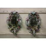 An attractive pair of Sitzendorf porcelain cartouche shaped Girandoles, each profusely decorated and