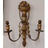 A pair of carved giltwood two branch Wall Lights, each crested with a vase of flowers, issuing swags