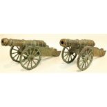 A pair of attractive brass Cannon Carriages, O.R.M., embossed design, each on spoked wheels, approx.