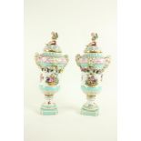 A pair of Berlin porcelain Urns and Covers, late 19th Century, each encrusted with flowers and