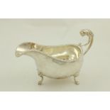 A silver Sauceboat, in the George III style, London 1937, with lion mask handle and a gadroon