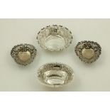 A pair of embossed and pierced silver pear shaped Bon Bon Dishes; another oval ditto; and one