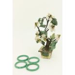 A set of four spinach colour Jadeite Chinese Rings, each approx. 6cms diameter; together with a
