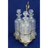 A Sheffield silver plated Decanter Stand, with three cut glass decanters, each with prism stopper,