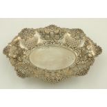 An Edwardian embossed and pierced silver Bread Dish, Birmingham 1900, with shell and C scroll