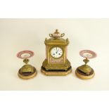 A 19th Century French gilt brass and porcelain Mantle Clock Garniture, the clock case with an