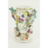 A 19th Century porcelain Meissen Vase, the floral encrusted design with cherubs and fruit, approx.