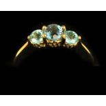 An attractive three stone aquamarine Ladies Ring, set in gold band, set with large central stone