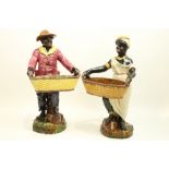 A pair of Victorian Majolica Figures, depicting African American cotton pickers, each holding a