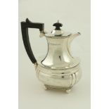 A silver Coffee Pot, of oval ogee form, London 1938, with ebonised handle, 23cms (9") 621g. (1)