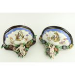 A pair of German flower encrusted porcelain Wall Brackets, of demi-lune form with cherub, and