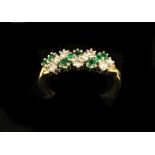 A fine quality ladies Cluster Ring, with eight diamonds and emeralds of variant sizes, set in gold