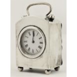 An arch top silver cased Carriage Clock, London 1927, with French movement, the swing handle above a
