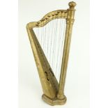 A 19th Century travelling or miniature Harp, decorated in gilt and floral design on shaped stepped