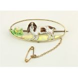 An attractive 18ct gold oval and enamel Brooch, decorated with a springer spaniel in a landscape,