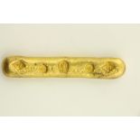 A Chinese gold coloured metal Ingot, with various marks, 59grs, 8cms (3 1/4'). (1)