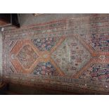 An attractive antique Middle Eastern woollen Carpet Runner,  the central panel on claret ground with