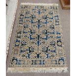 A semi-antique Middle Eastern blue and green ground geometric and diamond design Carpet, the large