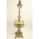 An ornate Edwardian brass Standard Oil Lamp, the brass reservoir with a telescopic reeded stem above